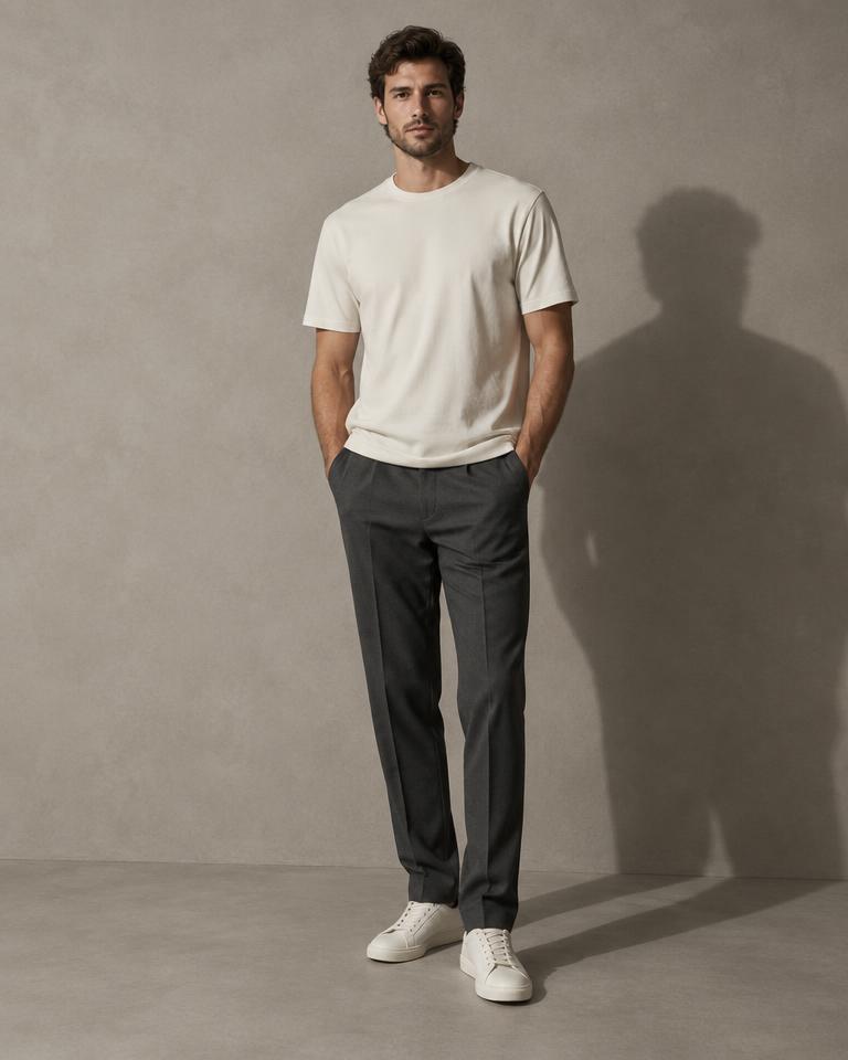 Man wearing a bone heavyweight tee and charcoal trousers